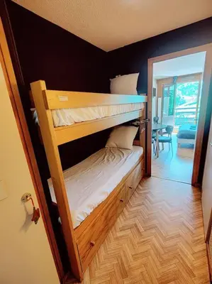 two bunk beds in a room with a hallway at Apartement vue Monblanc incroyable ski inout Prarion5 in Les Houches