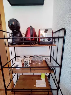 a shelf with dishes and other items on it at Apartement vue Monblanc incroyable ski inout Prarion5 in Les Houches