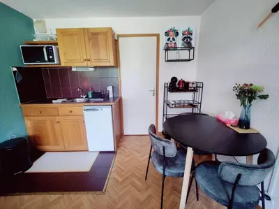 a kitchen with a table and chairs in a room at Apartement vue Monblanc incroyable ski inout Prarion5 in Les Houches