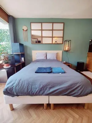 a bedroom with a large bed with blue sheets at Apartement vue Monblanc incroyable ski inout Prarion5 in Les Houches