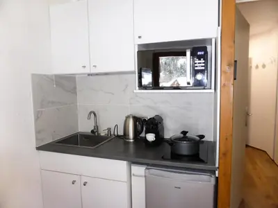a kitchen with a sink and a microwave at Résidence Combettes - Combettes D300 MAE-4071 in Les Contamines-Montjoie