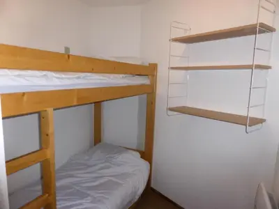 a small room with two bunk beds and a bed at Résidence Combettes - Combettes D300 MAE-4071 in Les Contamines-Montjoie