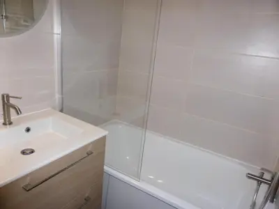 a white bathroom with a sink and a shower at Résidence Combettes - Combettes D300 MAE-4071 in Les Contamines-Montjoie