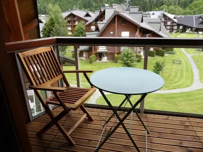 a glass table and a chair on a balcony at Résidence Combettes - Combettes D300 MAE-4071 in Les Contamines-Montjoie
