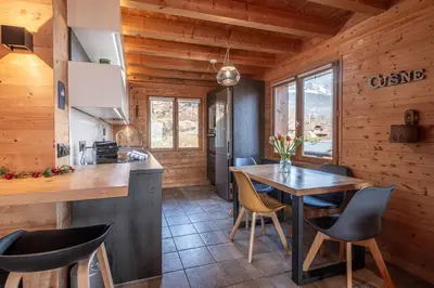 a kitchen and dining room with a table and chairs at SmartStay - Chalet face au mont Blanc in Sallanches