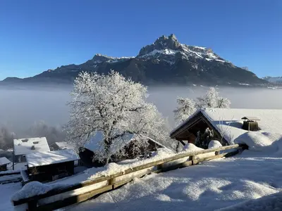 a house covered in snow with a mountain in the background at SmartStay - Chalet face au mont Blanc in Sallanches