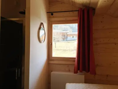 a bedroom with a window in a log cabin at Individual chalet for up to 12 people maximum in Les Contamines-Montjoie