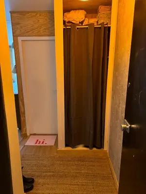 a door to a closet with a shower curtain at L’Atypique - centre Chamonix in Chamonix-Mont-Blanc