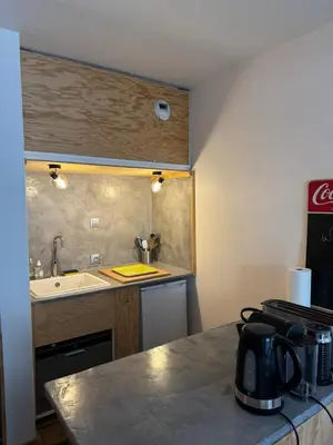 a small kitchen with a sink and a counter top at L’Atypique - centre Chamonix in Chamonix-Mont-Blanc
