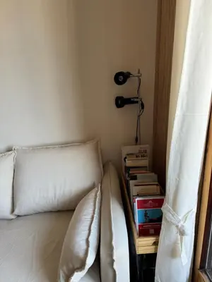 a bedroom with a bed and a table with books at L’Atypique - centre Chamonix in Chamonix-Mont-Blanc