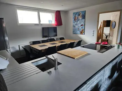 a kitchen and dining room with a table and chairs at Les Fées Mer : appart 150 m² hypercentre calme 10p in Chamonix-Mont-Blanc