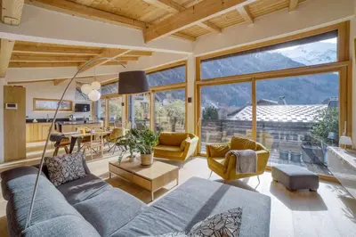 a living room with a blue couch and a table at Chalet 124 in Chamonix-Mont-Blanc