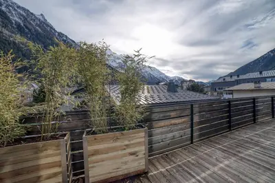 a balcony with a wooden fence and mountains at Chalet 124 in Chamonix-Mont-Blanc
