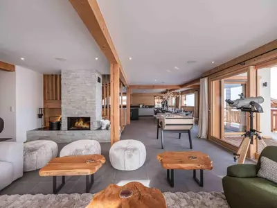a living room with a couch and a fireplace at Chalet moderne à Combloux avec piscine et espace bien-être - FR-1-569-160 in Combloux