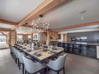 a dining room with a long table and chairs at Chalet moderne à Combloux avec piscine et espace bien-être - FR-1-569-160 in Combloux
