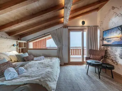 a bedroom with a large bed and a large window at Chalet moderne à Combloux avec piscine et espace bien-être - FR-1-569-160 in Combloux