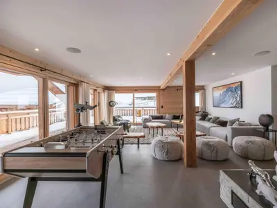 a living room with a ping pong table at Chalet moderne à Combloux avec piscine et espace bien-être - FR-1-569-160 in Combloux