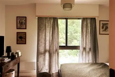 a bedroom with a bed and a large window at Family cocoon Prime Rochebrune location in Megève