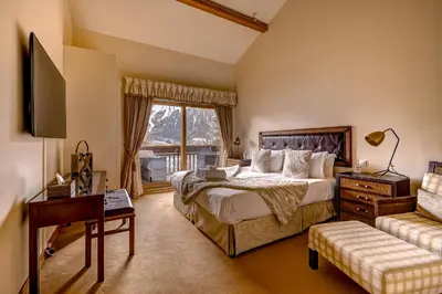 a bedroom with a large bed and a window at Chalet Serena - luxury 7 Bedroom Chalet, Pool & Spa in Les Houches