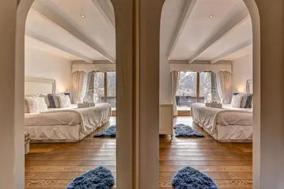a room with two beds and a window at Chalet Serena - luxury 7 Bedroom Chalet, Pool & Spa in Les Houches