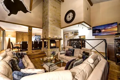a living room with a couch and a fireplace at Chalet Serena - luxury 7 Bedroom Chalet, Pool & Spa in Les Houches