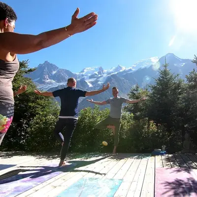 a group of people doing yoga in the mountains at Chalet Serena - luxury 7 Bedroom Chalet, Pool & Spa in Les Houches