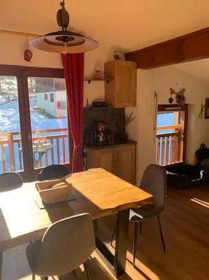 a large bed in a bedroom with a mirror at Chalet le Daim appartement 6 pers Vue Mont-Blanc in Combloux