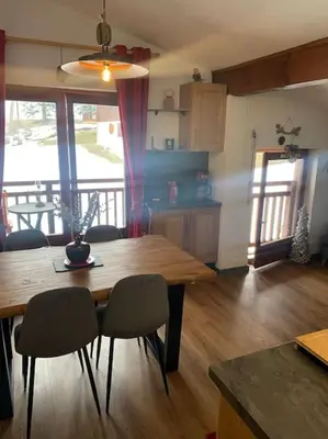 a living room with a christmas tree and a couch at Chalet le Daim appartement 6 pers Vue Mont-Blanc in Combloux