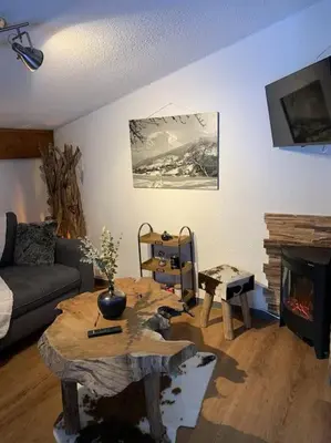 a large building with snow in front of it at Chalet le Daim appartement 6 pers Vue Mont-Blanc in Combloux