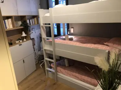 a bedroom with a bunk bed and a desk at Appart Centre Chamonix Grande Terrasse Mont Blanc in Chamonix-Mont-Blanc