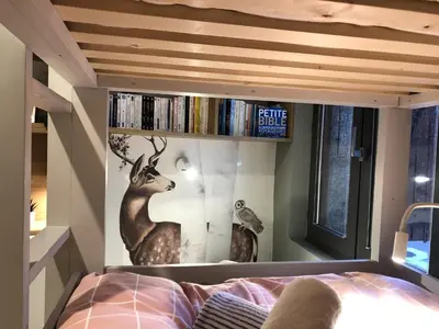 a bedroom with a mural of a deer on the wall at Appart Centre Chamonix Grande Terrasse Mont Blanc in Chamonix-Mont-Blanc
