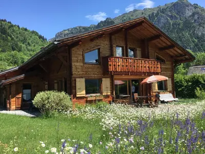 a log cabin in a field of flowers at La Planque des Marmottes in Servoz