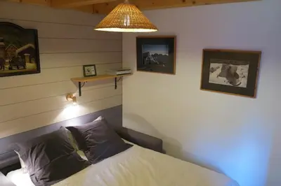 a bedroom with a bed and a lamp at La Planque des Marmottes in Servoz