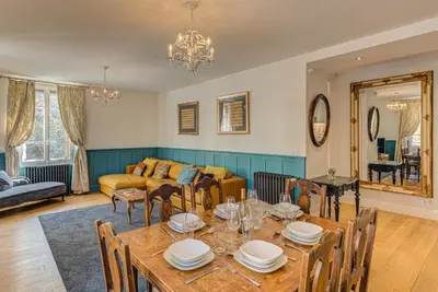a living room with a table and a couch at Apartment Aiguille du Midi Central Chamonix - Alpes Travel - Sleeps 6 in Chamonix-Mont-Blanc