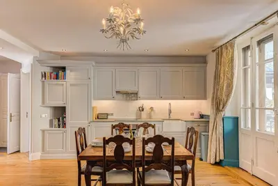a kitchen with a table and chairs and a chandelier at Apartment Aiguille du Midi Central Chamonix - Alpes Travel - Sleeps 6 in Chamonix-Mont-Blanc