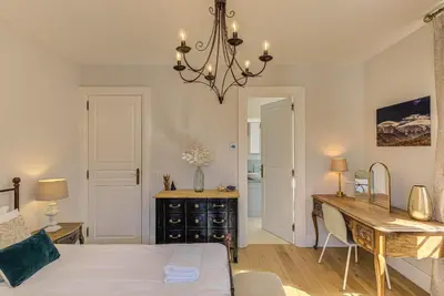 a bedroom with a bed and a desk and a table at Apartment Aiguille du Midi Central Chamonix - Alpes Travel - Sleeps 6 in Chamonix-Mont-Blanc