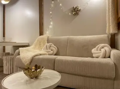 a living room with a couch and a table at Terrasse vue Mont Blanc, centre Chamonix in Chamonix-Mont-Blanc