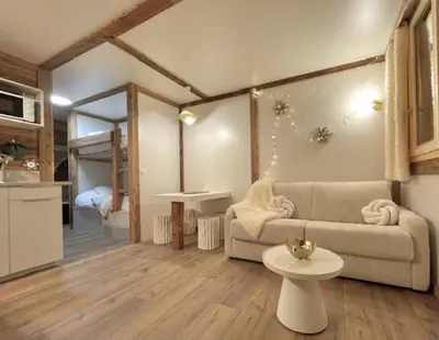 a living room with a couch and a table at Terrasse vue Mont Blanc, centre Chamonix in Chamonix-Mont-Blanc