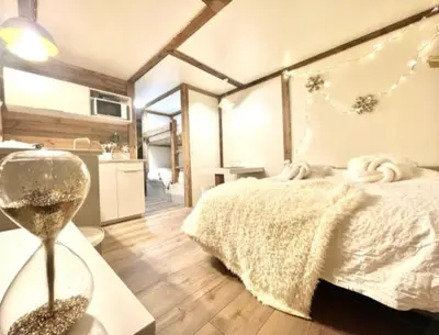 a bedroom with a bed and a table with a clock at Terrasse vue Mont Blanc, centre Chamonix in Chamonix-Mont-Blanc