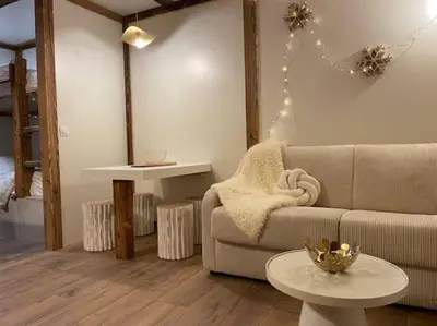 a living room with a couch and a table at Terrasse vue Mont Blanc, centre Chamonix in Chamonix-Mont-Blanc