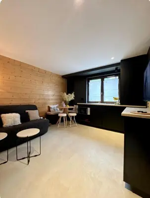 a living room with a couch and a table at Appartement F2 Bis centre de Megève in Megève