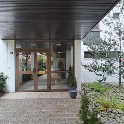 a front door of a building with a potted plant at Casa Peghera, Chamonix (hypercentre) in Chamonix-Mont-Blanc