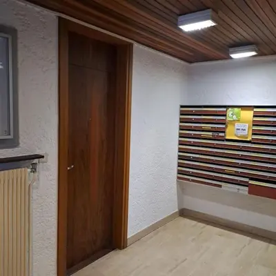 a room with a wooden door and a wall at Casa Peghera, Chamonix (hypercentre) in Chamonix-Mont-Blanc