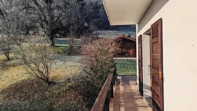 a door to a house with a view of a field at Spacieux T3 Parking FREE WIFI Haut-Débit in Magland