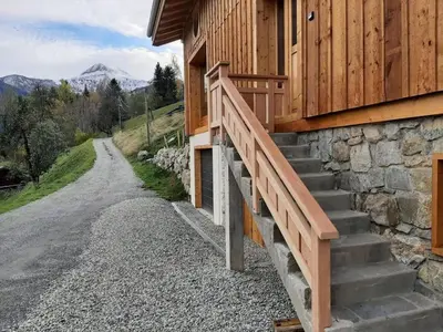 a set of stairs to a house with a stone wall at Chalet 3 chambres, 11 personnes près du domaine skiable, parking gratuit, Chez Pépé à Saint-Gervais in Saint-Gervais-les-Bains