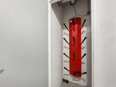 a red fire hydrant in a corner of a wall at 4 pieces centre village in Les Carroz d'Araches