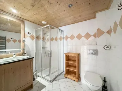 a bathroom with a shower and a toilet and a sink at 4 pieces centre village in Les Carroz d'Araches