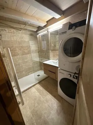 a small bathroom with a shower and a microwave at Le Wood Megève in Megève