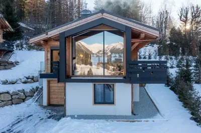 a log cabin with a hot tub on a deck at Chalet Seven Summits - Pool - Sauna - Jacuzzi - By Cozee Rentals in Chamonix-Mont-Blanc