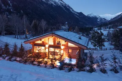 a hot tub in the backyard of a wooden house at Chalet Seven Summits - Pool - Sauna - Jacuzzi - By Cozee Rentals in Chamonix-Mont-Blanc